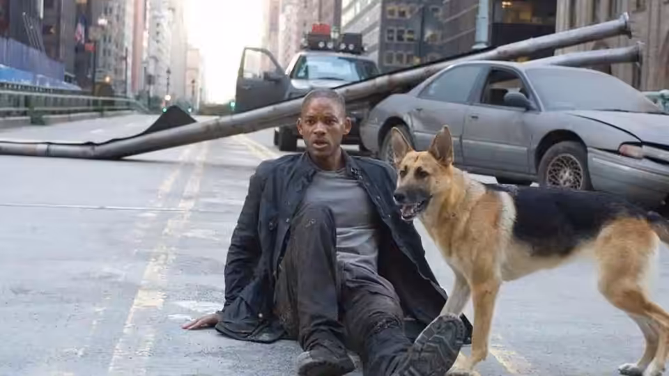 Robert Neville (Will Smith) sits on a deserted city street beside his German Shepherd