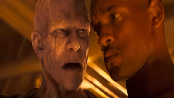 Robert Neville (Will Smith) faces a pale infected man in a dimly lit room
