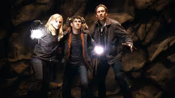 Abigail Chase (Diane Kruger), Riley Poole (Justin Bartha), and Ben Gates (Nicolas Cage) explore a cave with flashlights