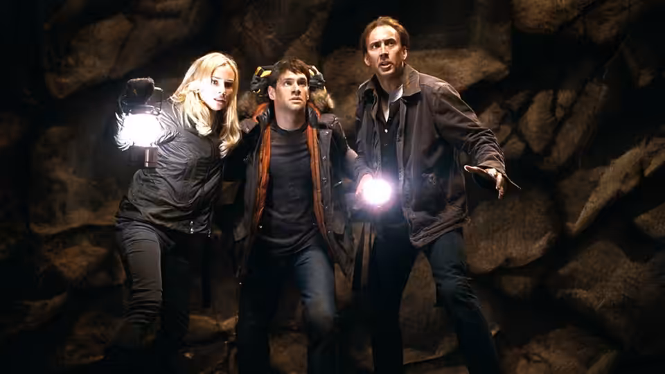 Abigail Chase (Diane Kruger), Riley Poole (Justin Bartha), and Ben Gates (Nicolas Cage) explore a cave with flashlights