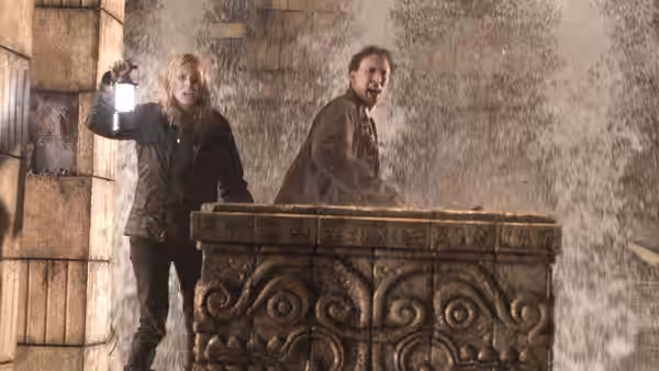 Abigail Chase (Diane Kruger) and Ben Gates (Nicolas Cage) stand behind a carved stone structure in a flooded chamber
