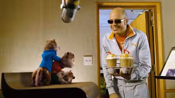 Ian (David Cross) offers treats to Alvin, Simon and Theodore in a recording room