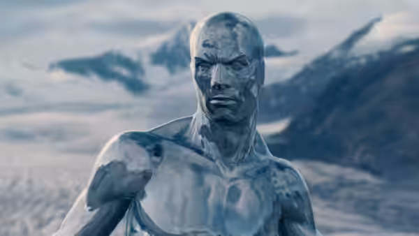 The Silver Surfer (Doug Jones) stands against a snowy mountain landscape
