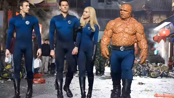 Reed Richards (Ioan Gruffudd), Johnny Storm (Chris Evans), Sue Richards (Jessica Alba), and Ben Grimm (Michael Chiklis) walk through a wrecked street