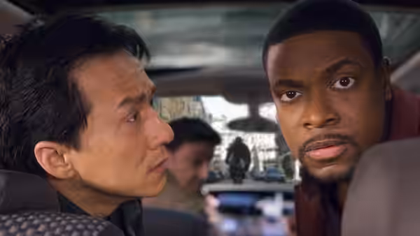 Yan Naing Lee (Jackie Chan) and James Carter (Chris Tucker) sit together inside a vehicle