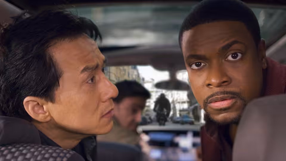 Yan Naing Lee (Jackie Chan) and James Carter (Chris Tucker) sit together inside a vehicle