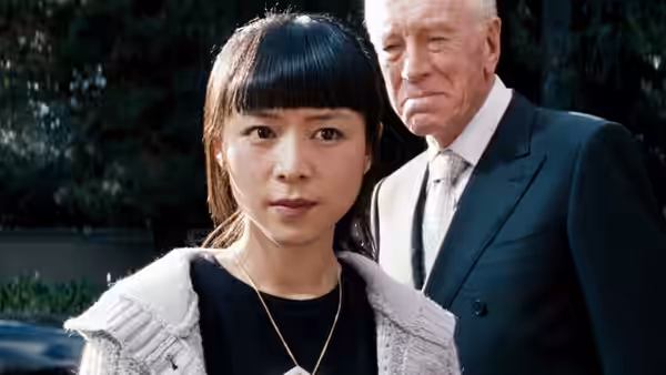 Soo Yung (Zhang Jingchu) stands in front of an older man in a suit