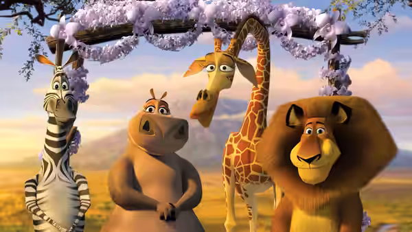 Marty, Gloria, Melman and Alex stand beneath a flower-covered arch on the savanna