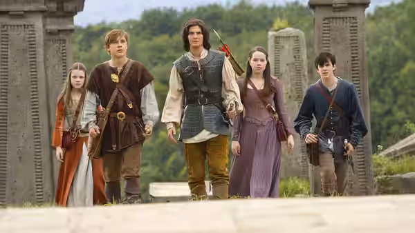 Prince Caspian (Ben Barnes) walks through stone pillars with the four Pevensie siblings