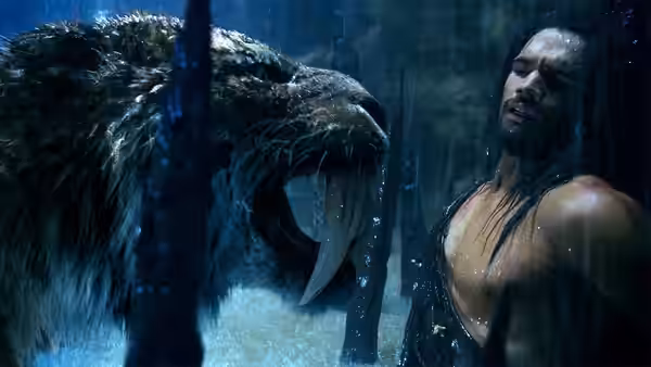 D’Leh (Steven Strait) faces a saber-toothed cat in a dark forest