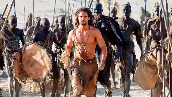 D’Leh (Steven Strait) walks among armed warriors carrying spears and shields