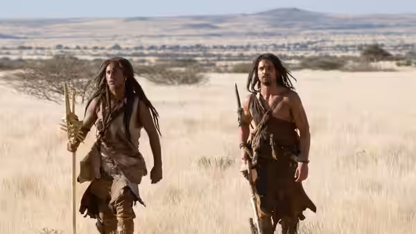 D’Leh (Steven Strait) and Tic-Tic (Cliff Curtis) cross a dry grassland
