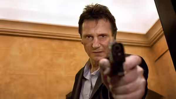 Bryan Mills (Liam Neeson) aims a pistol inside a tiled room