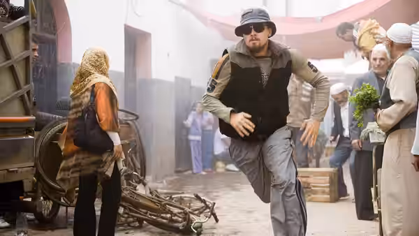 Roger Ferris (Leonardo DiCaprio) runs through a crowded market in disguise