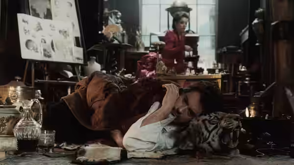 Sherlock Holmes lies on the floor amid overturned curios as a woman watches from behind the counter