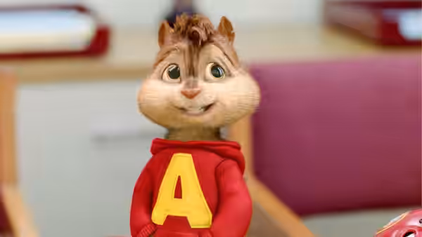 Alvin stands alone in his red sweatshirt inside a room