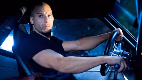 Dominic Toretto grips the steering wheel inside a car