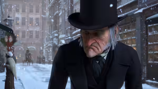 Scrooge walks through a snow-covered city street in his top hat