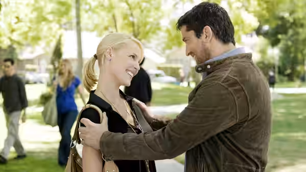 Mike Chadway (Gerard Butler) holds Abby Richter (Katherine Heigl) by the arms in a leafy park