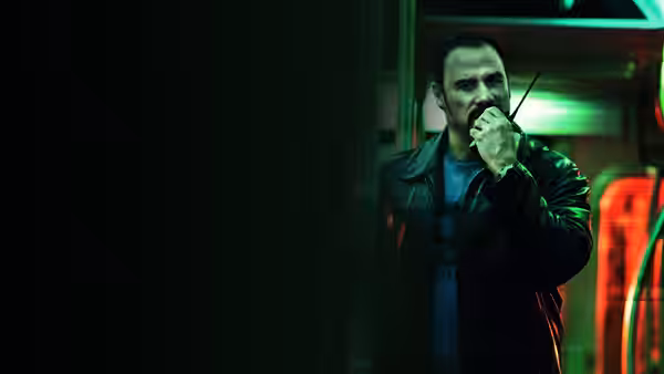 Ryder (John Travolta) speaks into a radio inside the subway