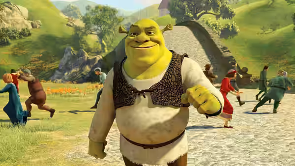 Shrek smiles while villagers dance in a sunlit village square