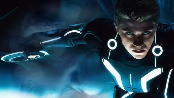 Sam Flynn (Garrett Hedlund) reaches forward while gliding through the Grid