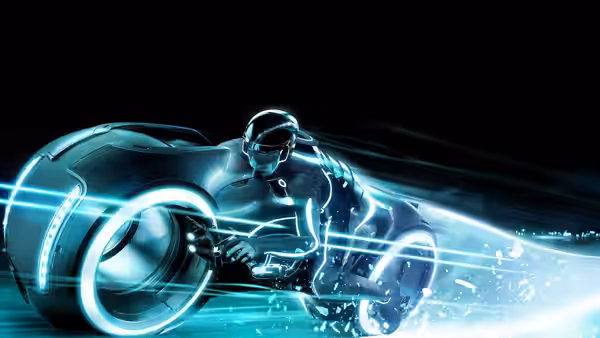 A helmeted rider speeds on a glowing light cycle through the Grid