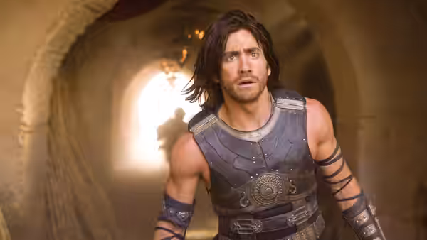 Prince Dastan (Jake Gyllenhaal) runs through a torchlit stone tunnel