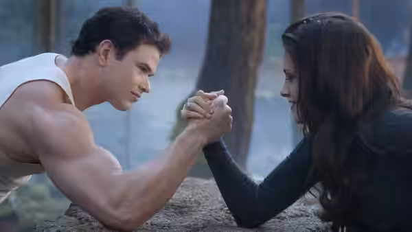 Edward Cullen and Bella Swan arm wrestle in a forest