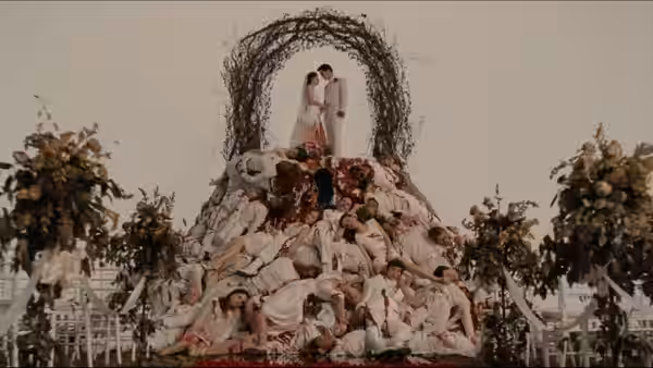 Bella Swan and Edward Cullen stand atop an elaborate wedding cake tableau