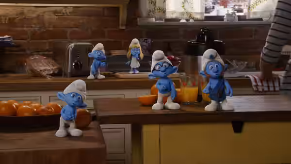 Smurfette and several Smurfs gather among oranges and appliances in a kitchen