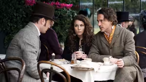 Irene Adler (Rachel McAdams), Sherlock Holmes (Robert Downey Jr.) and a man meet at an outdoor café