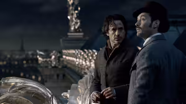 Sherlock Holmes (Robert Downey Jr.) and Dr. John Watson (Jude Law) look over a city from a balcony