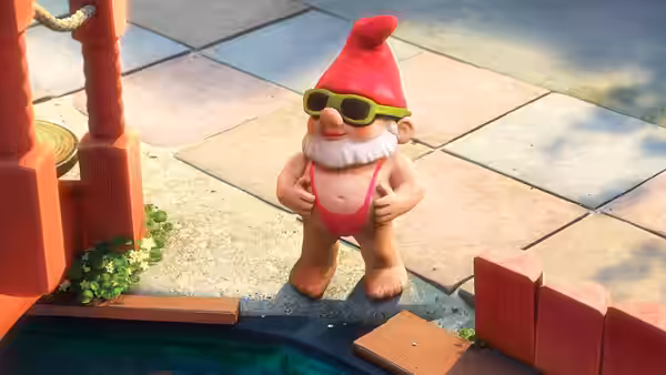 A bearded garden gnome in sunglasses and a red swimsuit stands beside a pool