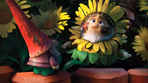 A flower-costumed gnome looks up at another gnome standing on a fence