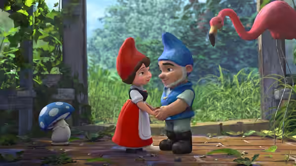 Juliet and Gnomeo hold hands in a garden beside a flamingo ornament