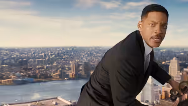 Agent J (Will Smith) leans over a rooftop edge above the city