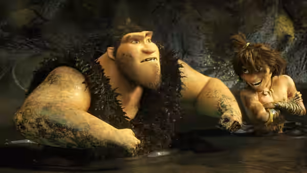 Grug (Nicolas Cage) and Guy (Ryan Reynolds) wade through dark water inside a cave