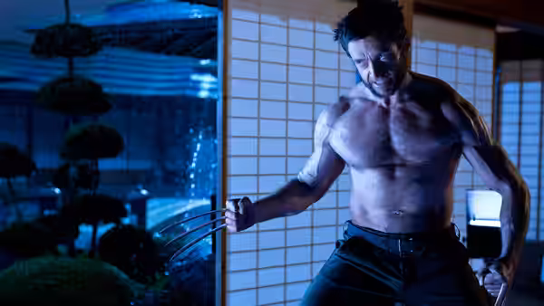 Logan (Hugh Jackman), shirtless and clawed, faces an opponent inside a Japanese room