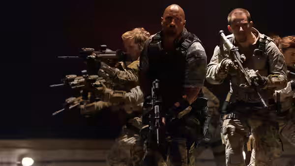 Roadblock (Dwayne Johnson) and Flint (D.J. Cotrona) advance with armed soldiers