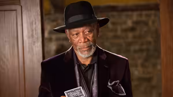 Thaddeus Bradley (Morgan Freeman) holds a playing card inside a room
