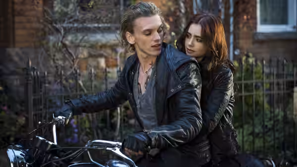 Jace Wayland (Jamie Campbell Bower) rides a motorcycle with Clary Fray behind him
