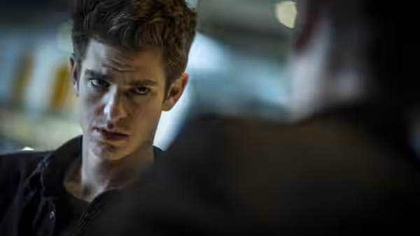 Peter Parker (Andrew Garfield) looks intently toward someone across the room