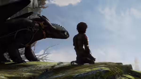 Hiccup kneels on a rocky cliff beside Toothless, gazing into the distance