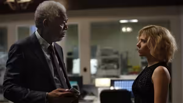Professor Norman (Morgan Freeman) talks with Lucy (Scarlett Johansson) in a laboratory