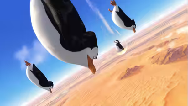 Four penguins dive headfirst through the sky above a desert
