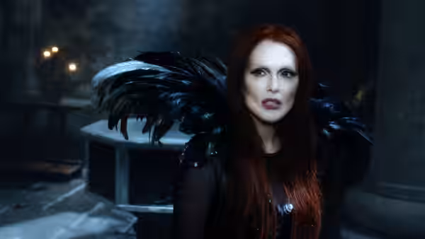 Mother Malkin (Julianne Moore) wears a black feathered cloak inside a dim room