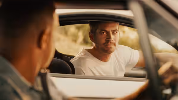Brian O'Conner (Paul Walker) looks through a car window at another man