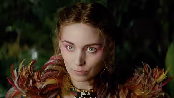 Tiger Lily (Rooney Mara) peers ahead in the jungle wearing a feathered garment