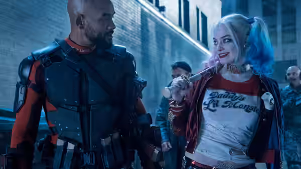 Deadshot (Will Smith) and Harley Quinn (Margot Robbie) walk together through a city alley